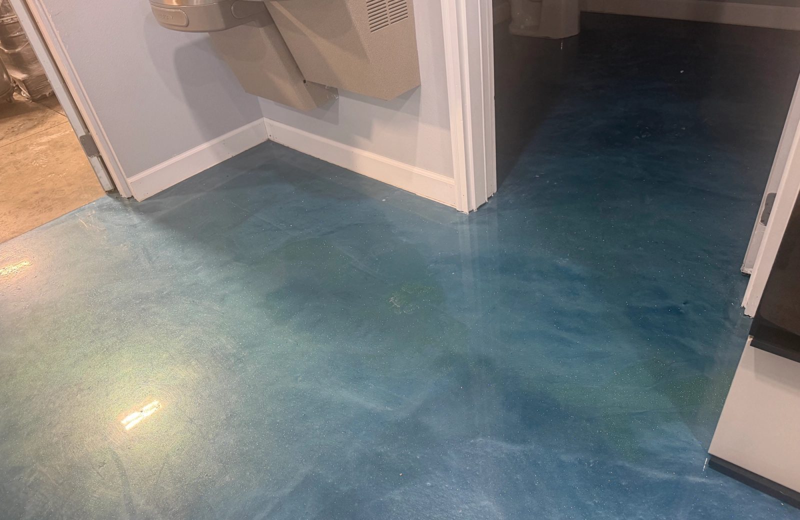 Blue metallic floor coating in a finished interior, Des Moines Iowa